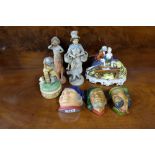 Group of figurines incl. piano player, 3 English character wall busts, lady with basket etc