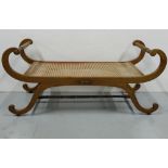 Regency Mahogany Window Seat with a bergere seat and scrolled side arms and legs, 48”w x 19”d