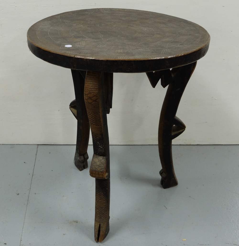Carved African Occasional Table with a circular top 22” dia, 25”h, on 3 shaped legs