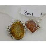 2 silver mounted Pendants with amber pastes (1 with a pearl) (2)