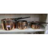 3 graduating antique copper saucepans, two with lids with handles, stamped