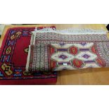 Two floor rugs – both red ground