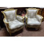 Matching Pair of Carved Gilt Wood Armchairs, the top rails decorated with urns and swags, bow shaped
