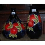Two modern Moorcroft Pottery Vases, blue ground, painted with peaches, one bulbous, both 13”h