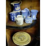 2 shelves Wedgewood items – blue and white low vases, jug etc & set of 3 beige ground floral plates,