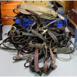 Large group of leather horse bridles, stirrups, bits etc