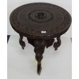 Carved Indian Occasional Table with elephant head and trunk shaped legs, bone tusks, 24” dia