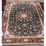 Black ground woven silk carpet with a medallion design and red border 2.9m x 2m
