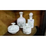 4 opalene glass perfume and powder bottles, hand painted with floral designs