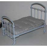 Miniature Metal Bed, painted blue, with ticking mattress, on castors, 2ft long