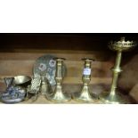 Shelf of brassware – pair low candlesticks, church candlestick, bell, figure of dog etc