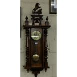 Spring Driven Wall Clock, in a mahogany case with a cream dial, turned side columns, 52”h, the