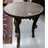 Carved African Occasional Table with a circular top 22” dia, 25”h, on 3 shaped legs