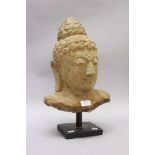 A hand carved stone figure of a Buddha on a metal stand, approx 47cm H