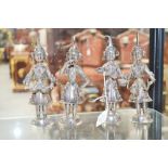 Four Indian tribal Hindu figures of musicians with bells marked silver to base, each approx 18cm