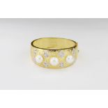 Ladies textured modernist 18ct gold cuff bangle. Mounted with three large south sea button pearls,