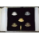 Presentation set of miniature rising sun tie tacks and lapel pins and by Mark Harris in original