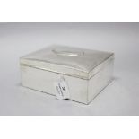 A large antique sterling silver box, with raised clean cartouche and bordered reed & ribbon