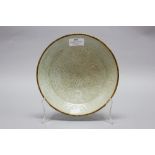 Chinese Dingyao celadon dish with protective copper edge, signed, approx 20cm dia