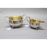 Georgian sterling silver sugar & creamer on ball feet, with gadroon borders, gilt wash interior, and