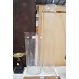 Tall slender glass vase along with a cylinder glass vase, approx 80cm H and smaller (2)