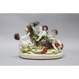 Continental porcelain figure group of cherubs mounting & playing with a Goat, makers mark to back
