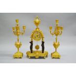 Antique French Empire mantle clock and garnitures, showing black cast figures to the supports of the
