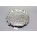 George II sterling silver Chippendale salver, chased floral decorated borders and stands on four