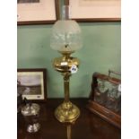 Victorian brass table lamp with clear etched shade.