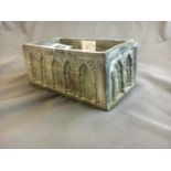 Neat terracotta planter with Gothic images.