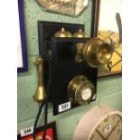 Brass and wood wall telephone.