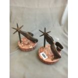Two stirrups mounted on marble bases.
