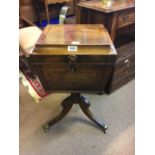 Regency inlaid mahogany cellaret in tripod stand and brass feet.