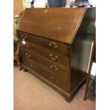 Georgian oak fall front bureau with four long drawers on bracket feet.