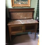 Edwardian inlaid mahogany wash stand with marble top.