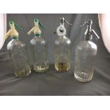 Four glass siphons.