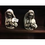 Pair of ceramic book ends in the form of religious figures.