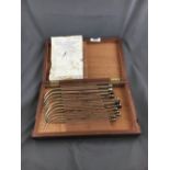 Cased set of twelve medical instruments.