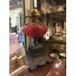 19th. C. table lamp with cast iron base and ruby bowl