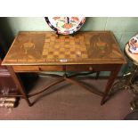 Edwardian inlaid mahogany games table with two draws on tapered legs.