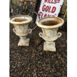 Pair of ornamental cast iron garden urns.