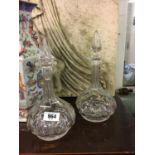 Two cut glass decanters.