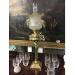 Brass oil lamp with corinthian column with brass bowl and etched shade.