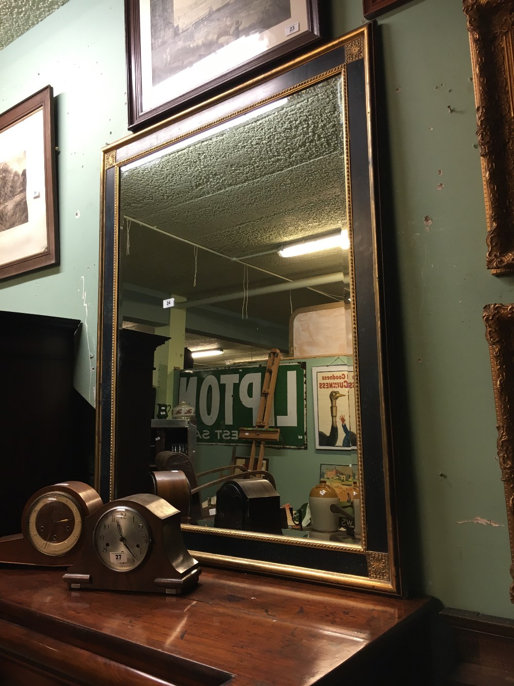 Ebonized gilt mirror with bevelled plate. { 139cm H X 114cm H }.