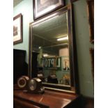 Ebonized gilt mirror with bevelled plate. { 139cm H X 114cm H }.