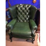 Green leather wing back chair.