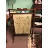 Edwardian mahogany fire screen with embroided panel.