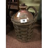 Stoneware flagon in original wicker holder.