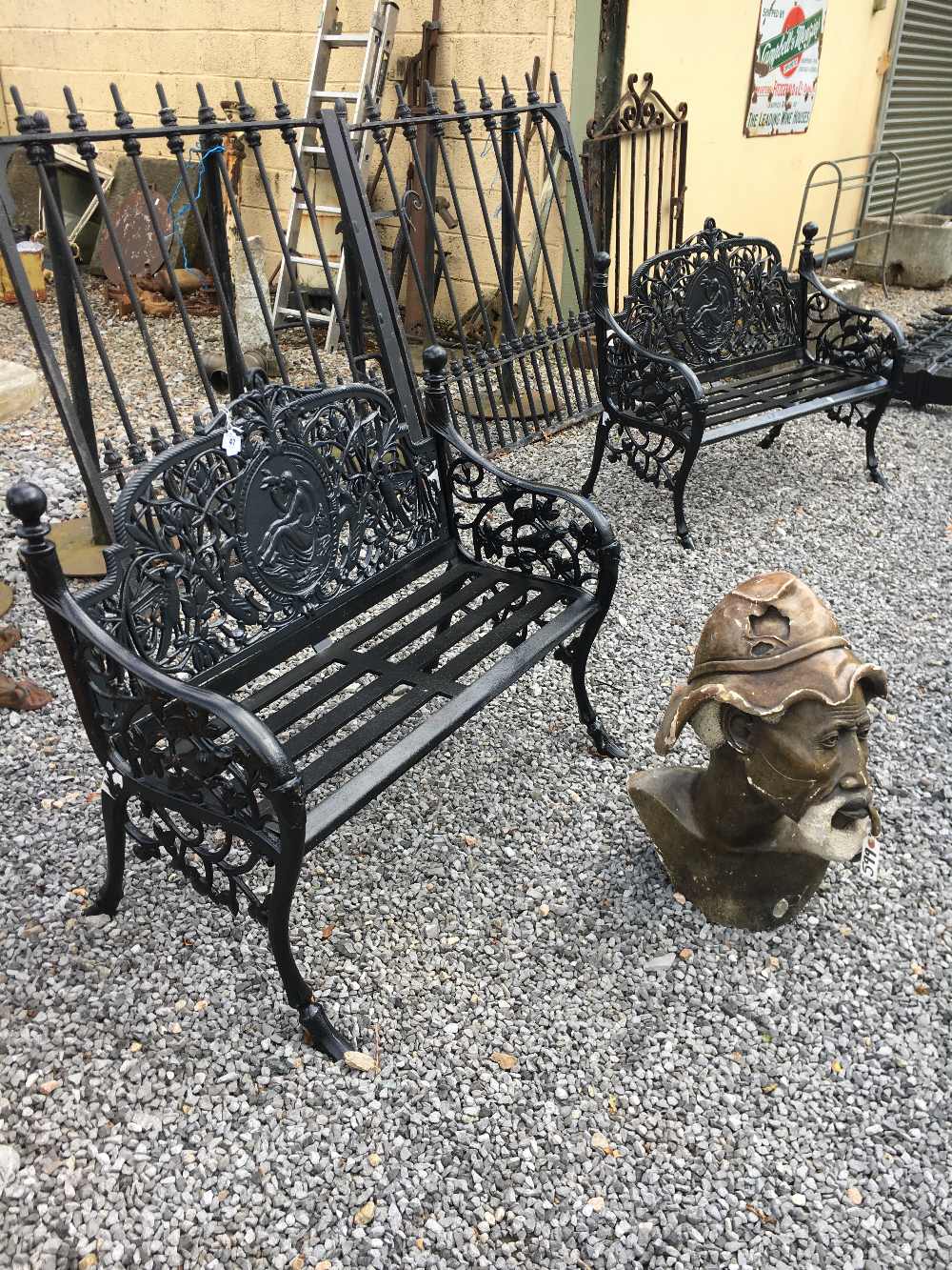 Pair of decorative cast iron black garden benches.