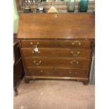 Georgian oak fall front bureau with four long drawers on bracket feet.